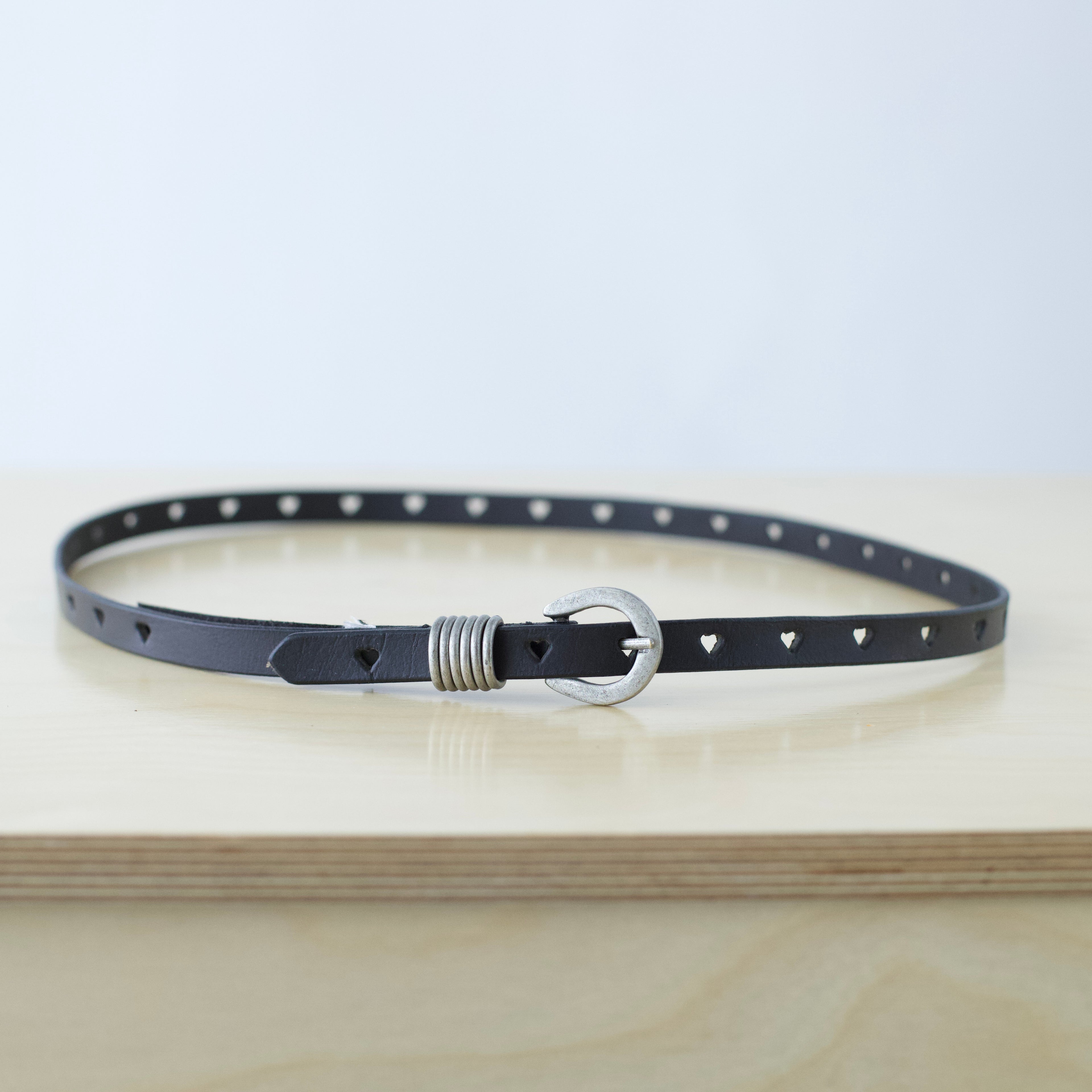 S/M Free People black leather belt with heart shaped cut outs